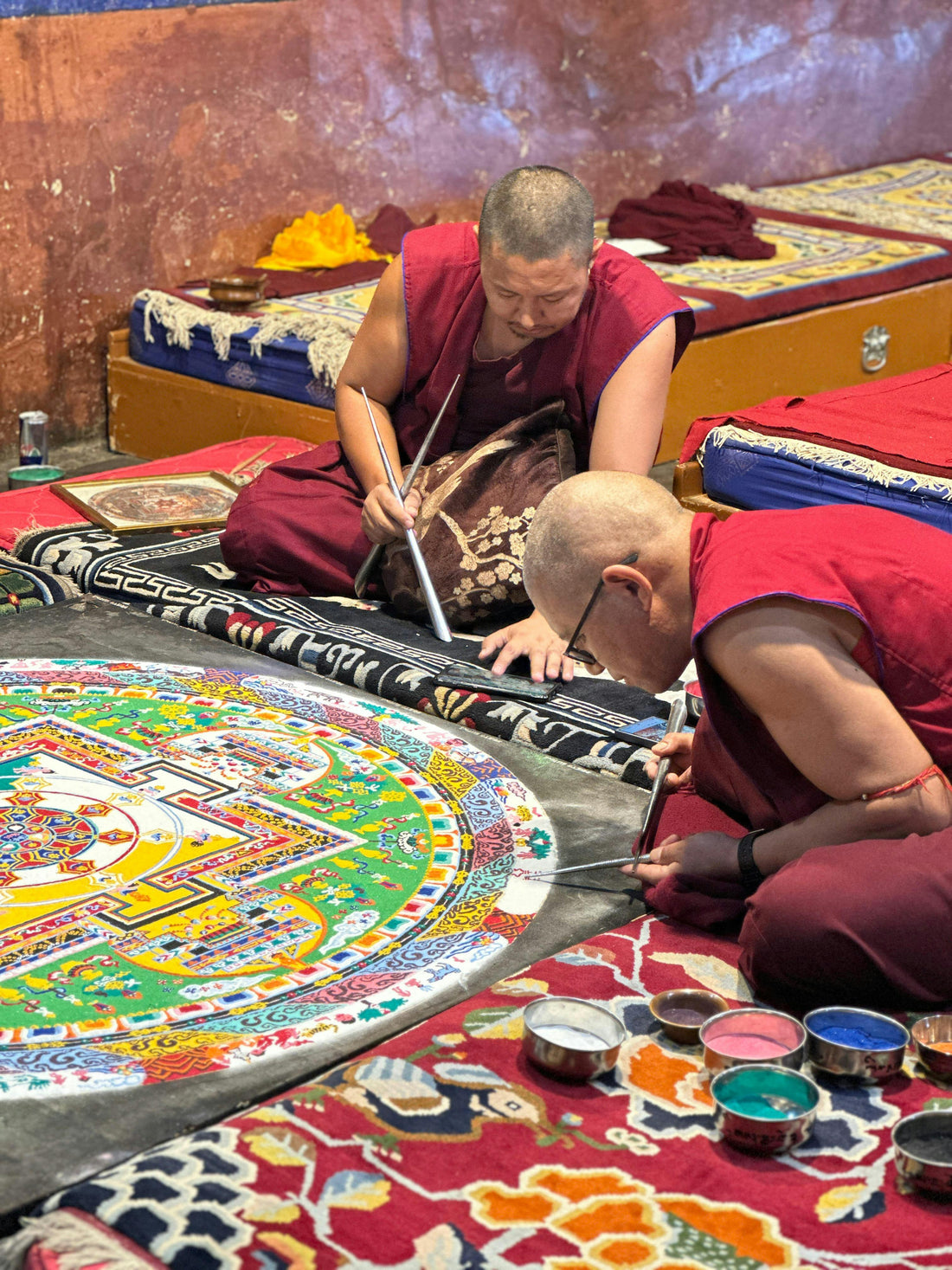 Tibetan monks creating a colourful sand mandala